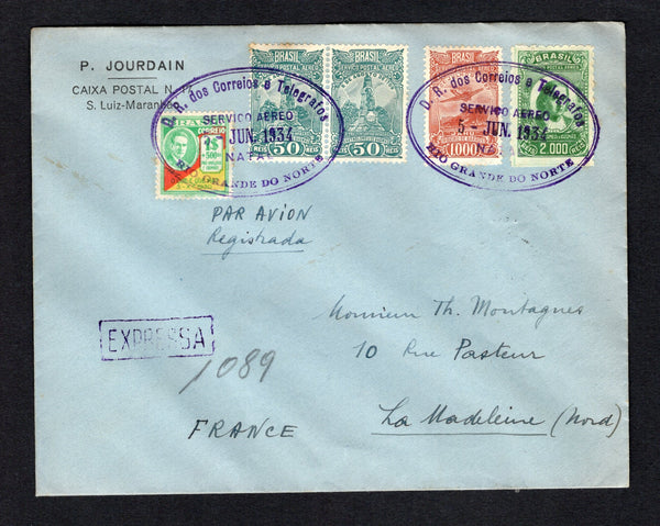 BRAZIL - 1934 - AIRMAIL EXPRESS: Registered Express cover franked with 1929 pair 50rs deep blue green, 1000rs red brown and 2000rs green 'Santos Dumont' AIR issue and 1931 $1+500rs green, scarlet & yellow 'Revolution of 3 October 1930' issue (SG 469, 473, 479 & 500) all tied by two strikes of large oval D.R. DOS CORREIOS E TELEGRAFOS SERVICIO AEREO NATAL RIO GRANDE DO NORTE cancel in purple dated 5 JUN 1934 with boxed 'EXPRESSA' marking alongside with manuscript express number. Addressed to FRANCE with tra