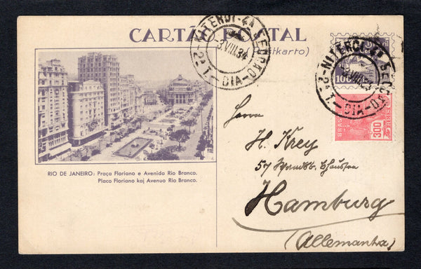 BRAZIL - 1934 - POSTAL STATIONERY: 100r dull violet on grey white 'Exposition' postal stationery view card (H&G 43) with view: 'Rio de Janeiro: Praca Floriano e Avenida Rio Branco' used with added 1920 300rs rose red 'Industry' issue (SG 384) tied by NITEROI 4A SECCAO 2A T- DIA cds dated 3.VIII.1934. Addressed to GERMANY with full commercial message on reverse. A rare card in used condition.  (BRA44325)