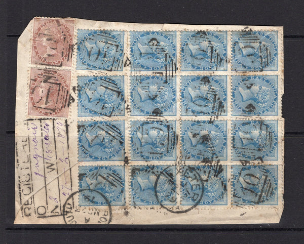 INDIA - 1865 - MULTIPLE: ½a blue on white paper block of sixteen and pair 1a pale brown QV issue with watermark tied on large registered piece by Diamond '10' numeral cancels with boxed registration cachet alongside with manuscript JAGNAIR of the office of origin plus weight and date. Originally addressed to UK with PORTSMOUTH and EXETER arrival cds's dated 1879. (SG 54 & 58)  (IND12628)
