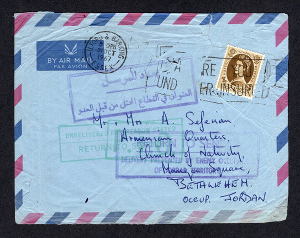 JORDAN - 1967 - MILITARY OCCUPATION: Incoming airmail cover from Great Britain franked with 1958 1/- bistre brown QE2 issue (SG 584) tied by ILFORD & BARKING machine cancel. Addressed to 'Mr & Mrs A Seferian, Armenian Quarters, Church of Nativity, Manger Square, Bethlehem, Occup. Jordan'. The cover was not able to be delivered with boxed 'RETURN TO SENDER DELIVERY PREVENTED BY ENEMY OCCUPATION OF JORDAN TERRITORY' cachet in violet and similar 'Arabic' cachet plus boxed 'UNDELIVERED FOR REASONS STATED RETUR