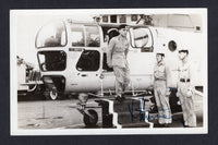 JORDAN - 1953 - ROYALTY: Postcard sized Photograph of King Hussein aged 18 stepping out of a helicopter signed by King Hussein on face with inscription on reverse 'King Hussein arrives by Helicopter' signed by him and given to Captain Jones H.M.S. Centaur 1953/1954. Interesting item.  (JOR/4264)