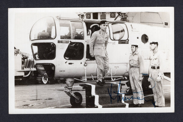 JORDAN - 1953 - ROYALTY: Postcard sized Photograph of King Hussein aged 18 stepping out of a helicopter signed by King Hussein on face with inscription on reverse 'King Hussein arrives by Helicopter' signed by him and given to Captain Jones H.M.S. Centaur 1953/1954. Interesting item.  (JOR/4264)