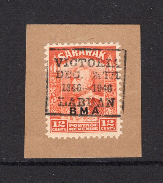 LABUAN - 1946 - SARAWAK USED IN LABUAN: 12c orange issue of Sarawak with 'BMA' overprint used on small piece with good strike of boxed 'VICTORIA DEC 24TH 1846 - 1946 LABUAN' cancel in black. (SG 114a)  (LAB/23625)