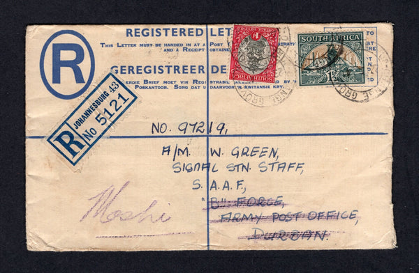 SOUTH AFRICA - 1941 - MILITARY & DESTINATION: 4d ultramarine postal stationery registered envelope (H&G C7) used with added 1933 1d grey & carmine and 1½d green & bright gold (SG 56/57) tied by CHANGE GROVE JOHANNESBURG cds's with 'JOHANNESBURG 43' registration label on front. Addressed to 'No. 97219, A/M W. Green, Signal Stn Staff, S.A.A.F., B Force, Army Post Office, Durban' then redirected to MOSHI (Tanganyika) with A.F.O. M.P.K. transit cds and BROKEN HILL N. RHODESIA transit cds plus MOSHI arrival cds