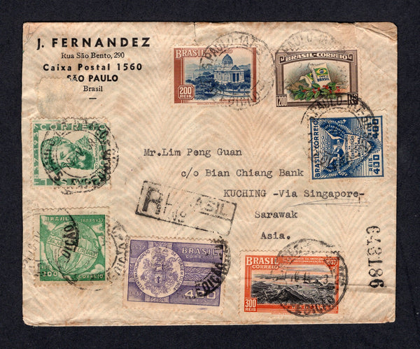BRAZIL - 1938 - DESTINATION: Registered cover franked with 1937 300rs black & orange, 300rs green, 200rs blue & brown, 400rs blue, 1938 1200rs multicoloured, 400rs violet & 400rs bluish green (SG 599, 601, 602, 609/610, 612 & 613) all tied by SAO PAULO cds's dated 16 IV 1938 with boxed registration markings on front & reverse. Addressed to KUCHING, SARAWAK, ASIA with typed 'VIA SINGAPORE' with various USA transit cds's plus SINGAPORE REGISTERED transit cds and KUCHING arrival cds all on reverse. Cover has 