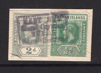 CAYMAN ISLANDS - Circa 1913 - CANCELLATION: ½d green and 2d pale grey GV issue on piece cancelled by average but complete strike of boxed EAST END GRAND CAYMAN RURAL POST COLLECTION cancel in violet. The piece has been repaired somewhat but and exceptionally rare cancel. (SG 41 & 43)  (CAY/27536)