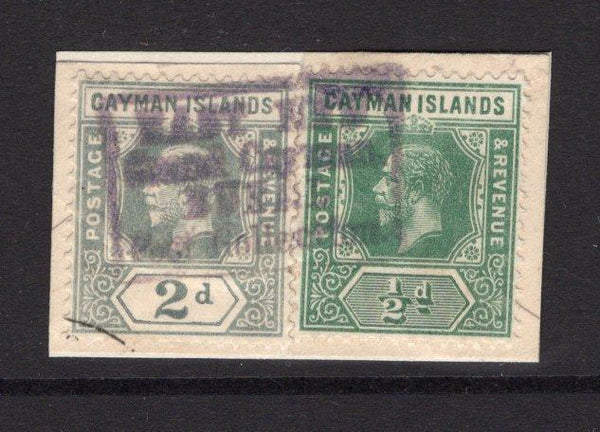 CAYMAN ISLANDS - Circa 1913 - CANCELLATION: ½d green and 2d pale grey GV issue on piece cancelled by average but complete strike of boxed EAST END GRAND CAYMAN RURAL POST COLLECTION cancel in violet. The piece has been repaired somewhat but and exceptionally rare cancel. (SG 41 & 43)  (CAY/27536)