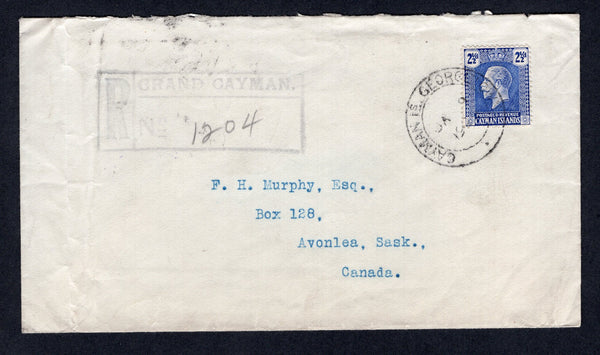 CAYMAN ISLANDS - 1929 - REGISTRATION: Registered cover franked with single 1921 2½d bright blue GV issue (SG 74) tied by GEORGETOWN cds dated JAN 9 1929 with large boxed 'GRAND CAYMAN' registration marking in purple alongside. Addressed to AVONLEA, SASK, CANADA with transit & arrival marks on reverse. Vertical crease at left.  (CAY/32863)