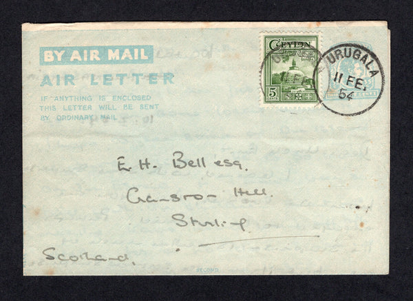 CEYLON - 1954 - POSTAL STATIONERY & CANCELLATION: 35c milky blue GVI postal stationery envelope (H&G FG11) used with added 1950 5c green (SG 414) tied by URUGALA cds. Addressed to UK.  (CEY/18556)