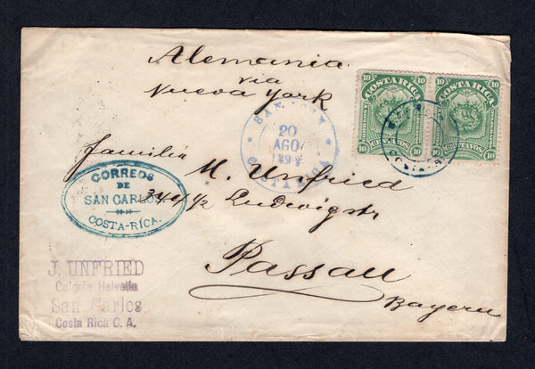 COSTA RICA - 1899 - CANCELLATION & SWISS COLONY: Cover with 'J. Unfried, Colonia Helvetia, San Carlos, Costa Rica' return address handstamp in purple on front franked with pair 1892 10c green 'Arms' issue (SG 35) tied by undated circular SAN CARLOS cancel in blue with fine strike of undated oval CORREOS DE SAN CARLOS COSTA RICA cancel also in blue alongside. Addressed to GERMANY with SAN JOSE transit cds on front and transit & arrival marks on reverse. Very scarce.  (COS/30312)
