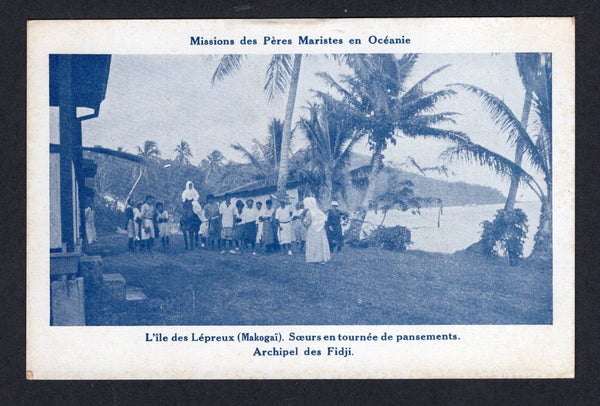 FIJI - 1910 - POSTCARD & LEPER COLONY: Blue tinted PPC 'Missions des Peres Maristes en Oceanie - L'ile des Lepreux (Makogai). Soers en tournee de pansements. Archipel des Fidji' showing lepers and nurses on grass by huts and the sea. Fine unused.  (FIJ/40156)