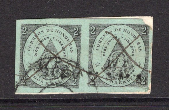 HONDURAS - 1866 - CLASSIC ISSUES: 2r black on green pair, one stamp with large margins the other cut into at right and corner fault used on small piece cancelled by two manuscript 'X' cancels, part PANAMA TRANSIT cancel and small part USA arrival cds showing an '1876' date. An exceptionally rare piece. There are only four recorded genuine covers known franked with this issue. (SG 1)  (HON/5096)