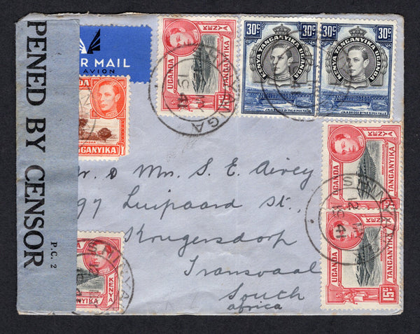 KENYA, UGANDA & TANGANYIKA - 1941 - CENSORED MAIL: Cover franked with 1938 10c red brown & orange, 4 x 15c black & rose red and 2 x 30c black & dull violet blue GVI issue (SG 134, 137 & 141) tied by SHINYANGA cds's and censored with printed black on blue 'OPENED BY CENSOR P.C.2' censor strip. Sent airmail to TRANSVAAL, SOUTH AFRICA with DARESSALAAM transit cds on reverse.  (KUT/38762)