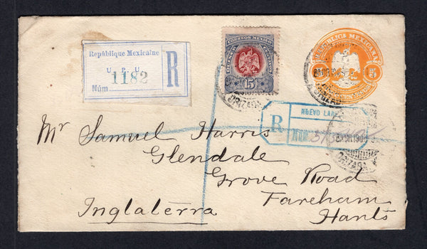 MEXICO - 1905 - POSTAL STATIONERY & REGISTRATION: 5c yellow postal stationery envelope (UPSS #E63, H&G 53) used with added 1899 15c purple & lavender 'Arms' issue (SG 271) tied by ORIZABA cds's with printed ultramarine on white registration label alongside. Addressed to UK with NUEVO LAREDO transit registration marking in blue on front  plus various transit & arrival marks on reverse.  (MEX/41435)