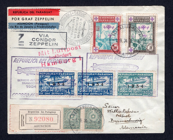 PARAGUAY - 1934 - ZEPPELIN: Registered cover franked with 1913 pair 1p 25c greenish blue, 1933 20c turquoise & lake and 2p green & sepia plus 1934 pair 4p 50c blue and 13p 50c blue green 'Zeppelin' issue with '1934' overprint (SG 235, 457, 461, 469 & 471) tied by SCIO AEREO POSTAL PARAGUAY cds's dated 1. 9.1934 and by large boxed illustrated 'Zeppelin' cachet's in purple with printed red white & blue 'POR GRAF ZEPPELIN ASUNCION (Paraguay) via Rio de Janeiro a Friedrichshafen' airmail label alongside. Flown