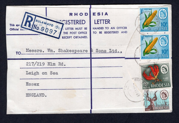 RHODESIA - 1969 - DUAL CURRENCY ISSUE & REGISTRATION: Registered envelope franked with 1966 3d chocolate & pale blue and 6d carmine red, yellow & deep dull green plus pair 1967 1/- (10c) yellow, green & greenish blue 'Dual Currency' issue (SG 376, 378 & 409) tied by BULAWAYO cds's with printed blue & white 'BULAWAYO (5)' registration label alongside. Addressed to UK.  (RHO/22170)