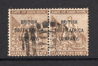 RHODESIA - 1896 - PROVISIONAL ISSUE: 2d deep bistre 'BRITISH SOUTH AFRICA COMPANY' overprint on Cape of Good Hope issue. A fine used pair with good strike of barred numeral '679' cancel of TATI located in Bechuanaland but under the control of the Rhodesian P.O. Very scarce. (SG 60)  (RHO/38075)
