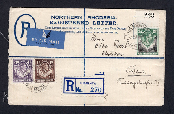 RHODESIA - NORTHERN RHODESIA - 1939 - POSTAL STATIONERY & HIGH VALUE FRANKING: 4d dull blue GVI postal stationery registered envelope (H&G C2) used with added 1938 1d brown, 4d dull violet and a top marginal 2/6 black and green with '223' sheet number handstamp in top margin (SG 27, 36 & 41) all tied by LUANSHYA cds's dated 5 MAY 1939 with printed blue on white 'LUANSHYA' registration label and blue airmail label alongside. Addressed to GERMANY with transit & arrival marks on reverse. The 2/6 is very scarc