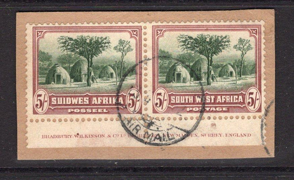 SOUTH WEST AFRICA - 1931 - DEFINITIVE ISSUE: 5/- sage green & red brown 'Herero Huts' issue, a superb bottom marginal pair with 'Bradbury Wilkinson & Co. Ld. Engravers, New Malden, Surrey, England' IMPRINT in margin tied on piece by AIRMAIL cds. (SG 83)  (SWA/33465)
