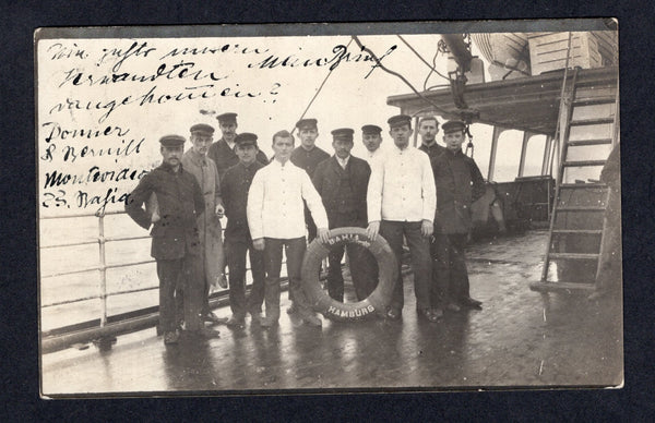 URUGUAY - 1914 - MARITIME & POSTCARD: Black & white real photographic PPC showing the crew of a ship on deck with the ships lifebuoy inscribed 'BAHIA HAMBURG'. The card is datelined 'S S Bahia, Montevideo 27.11' and 'Via Italia' written in German franked with 1912 2c rose (SG 324) tied by MONTEVIDEO cds. Addressed to GERMANY. A superb item.  (URU/31961)