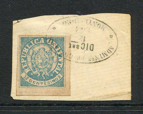 URUGUAY - 1864 - CLASSIC ISSUES: 12c pale blue 'Arms' issue a superb bottom marginal copy, four margins tied on small piece by oval MONTEVIDEO cancel dated 12 DEC 1864. (SG 23a)  (URU/3307)
